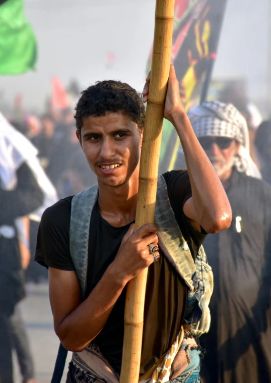 a person holds on to a stick in the street