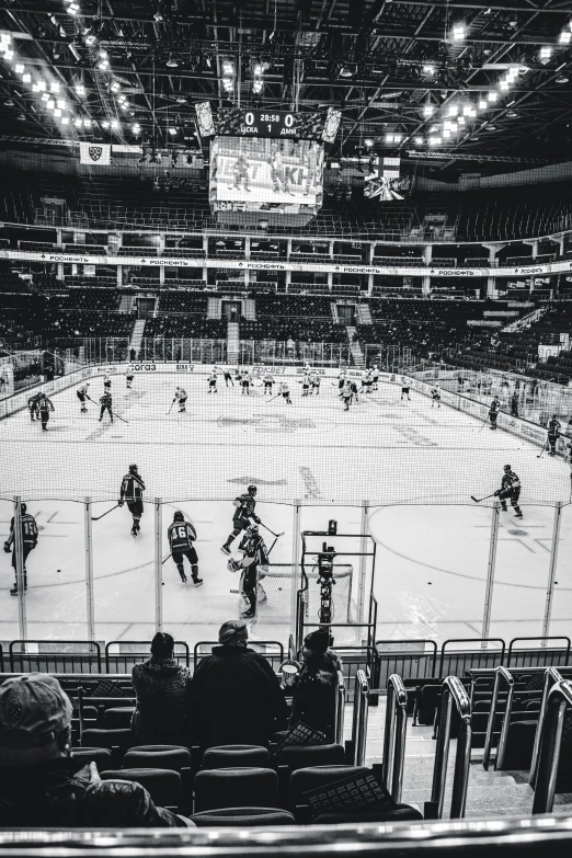 a large hockey rink with many players playing