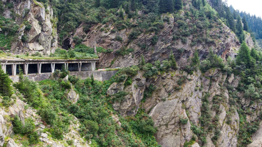 mountains and cliffs surrounding a river in the middle of nowhere