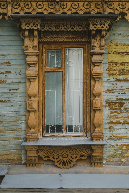 a wooden window sits in the corner of an old, dirty building