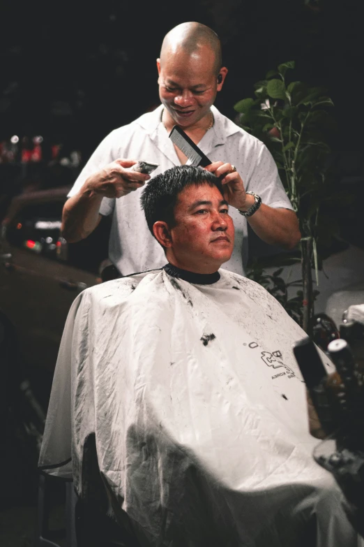 an employee is shaving a client's hair in a salon