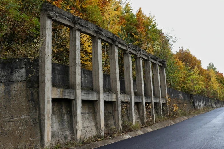 a concrete fence that is lined up along a road