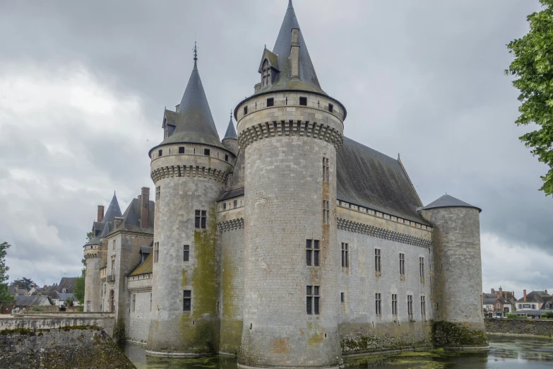 a castle style building with many turrets on the top of it