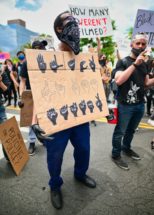 people protesting in protest with cardboard signs and scar