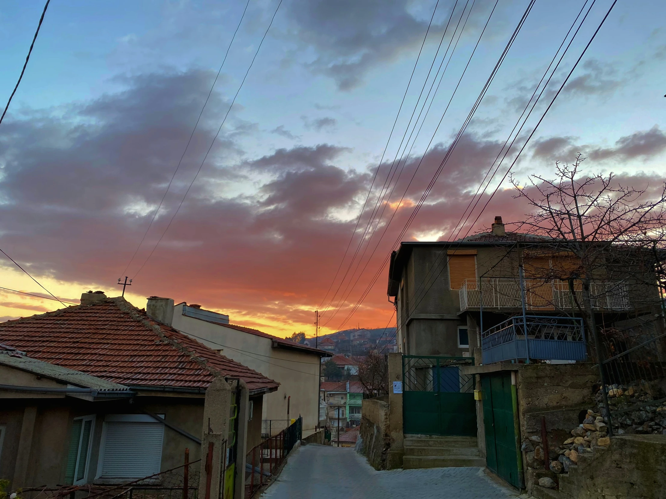 there is a sky in the background and houses and power lines