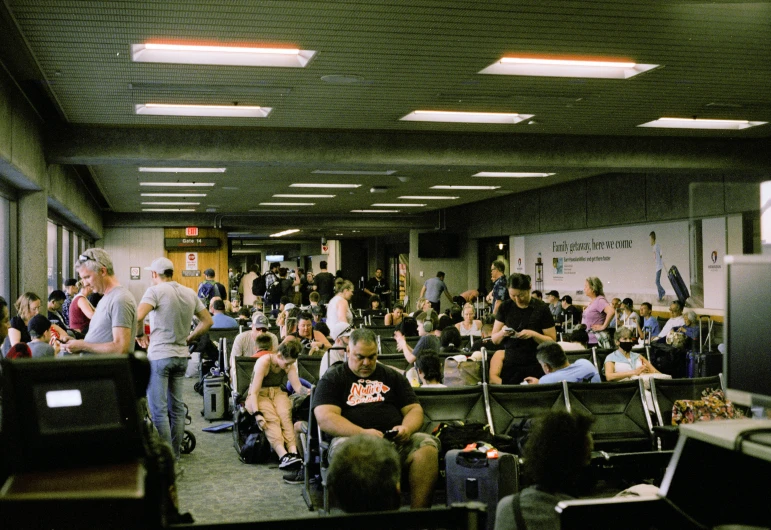 a group of people sitting around in a room with laptops