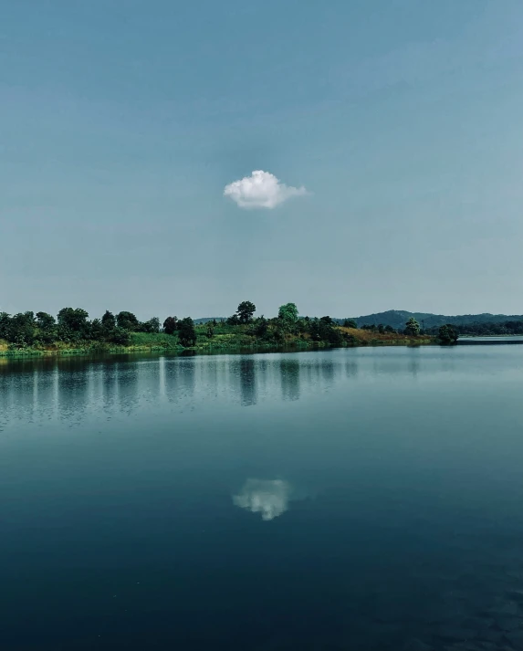 an airplane flying over a lake in the daytime