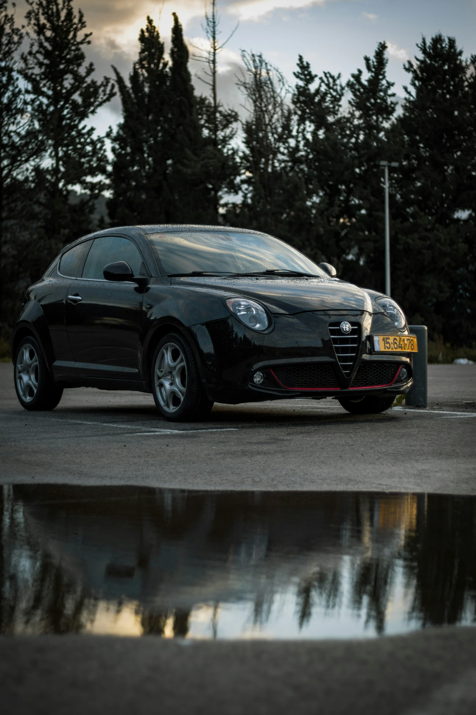 a small black vehicle parked next to a lake