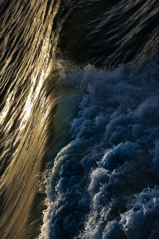 the water is coming towards the shore while a wave crashes