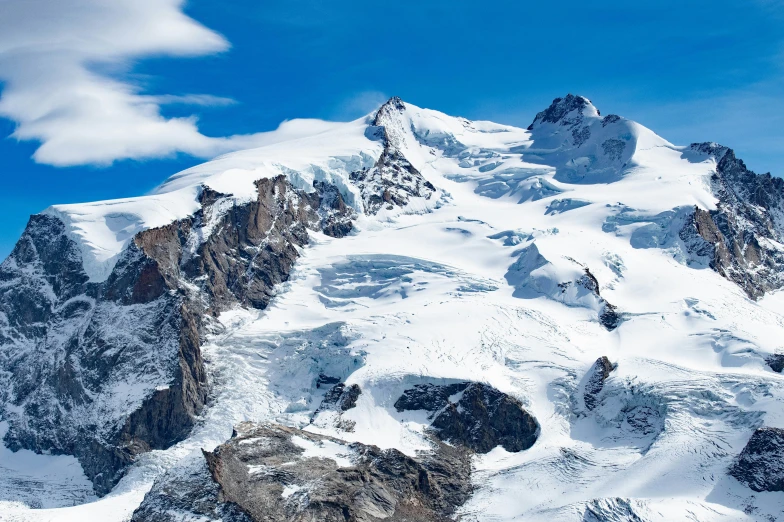 a mountain with a snow covered top is pictured in the foreground