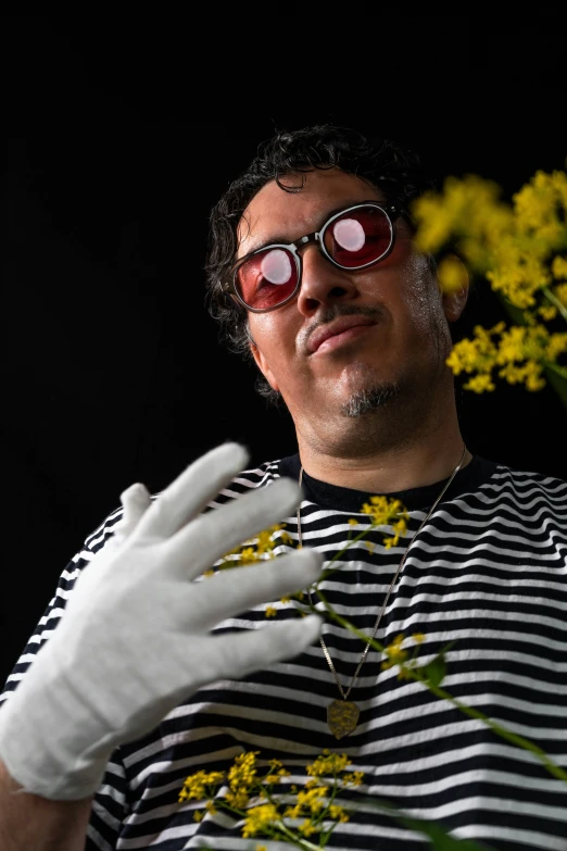 a person that is wearing gloves and holding flowers