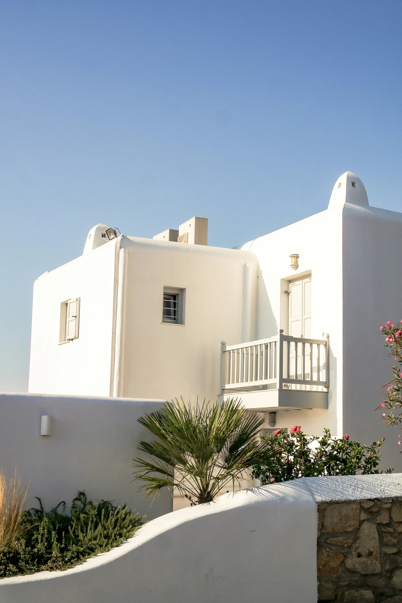 a white building with windows is shown on a sunny day