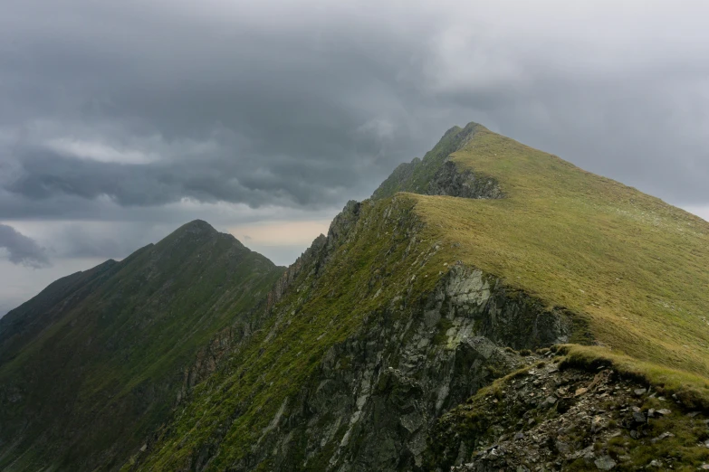 some big green hills on a cloudy day