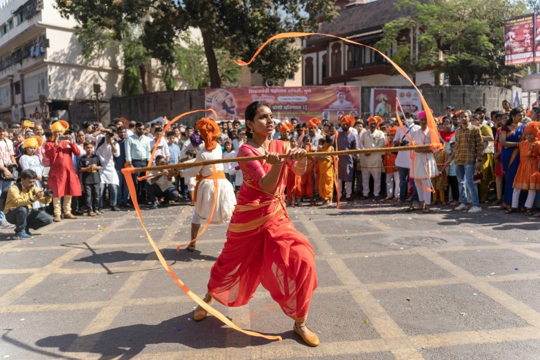 a person is using a bow and arrow to target a crowd