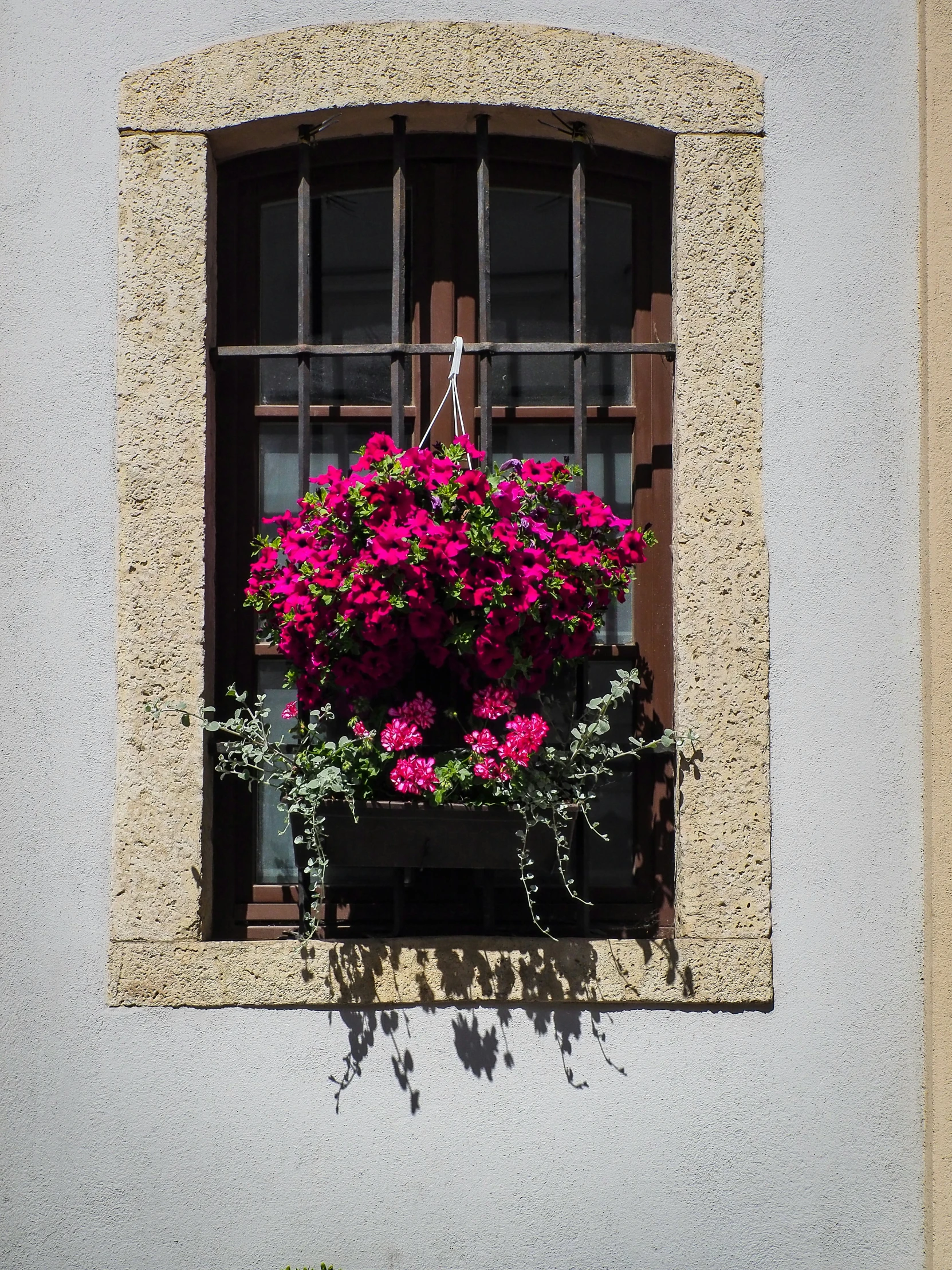 a window box filled with flowers next to a wall