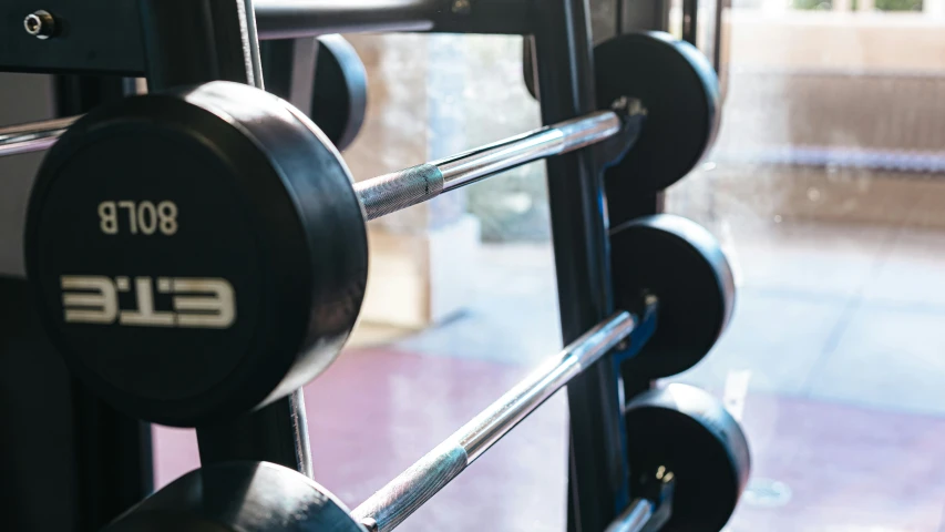 close up of three black bumper plates next to a door