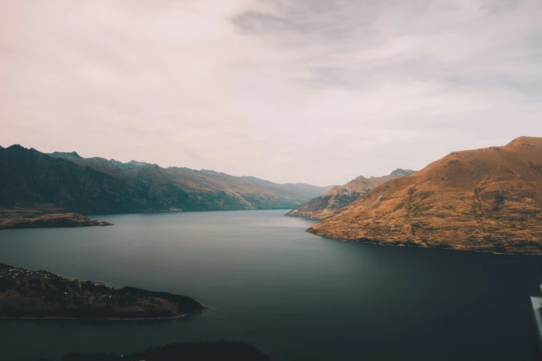 a boat in a body of water surrounded by mountains