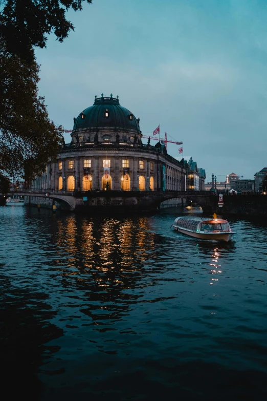 an old building and two boats on the river