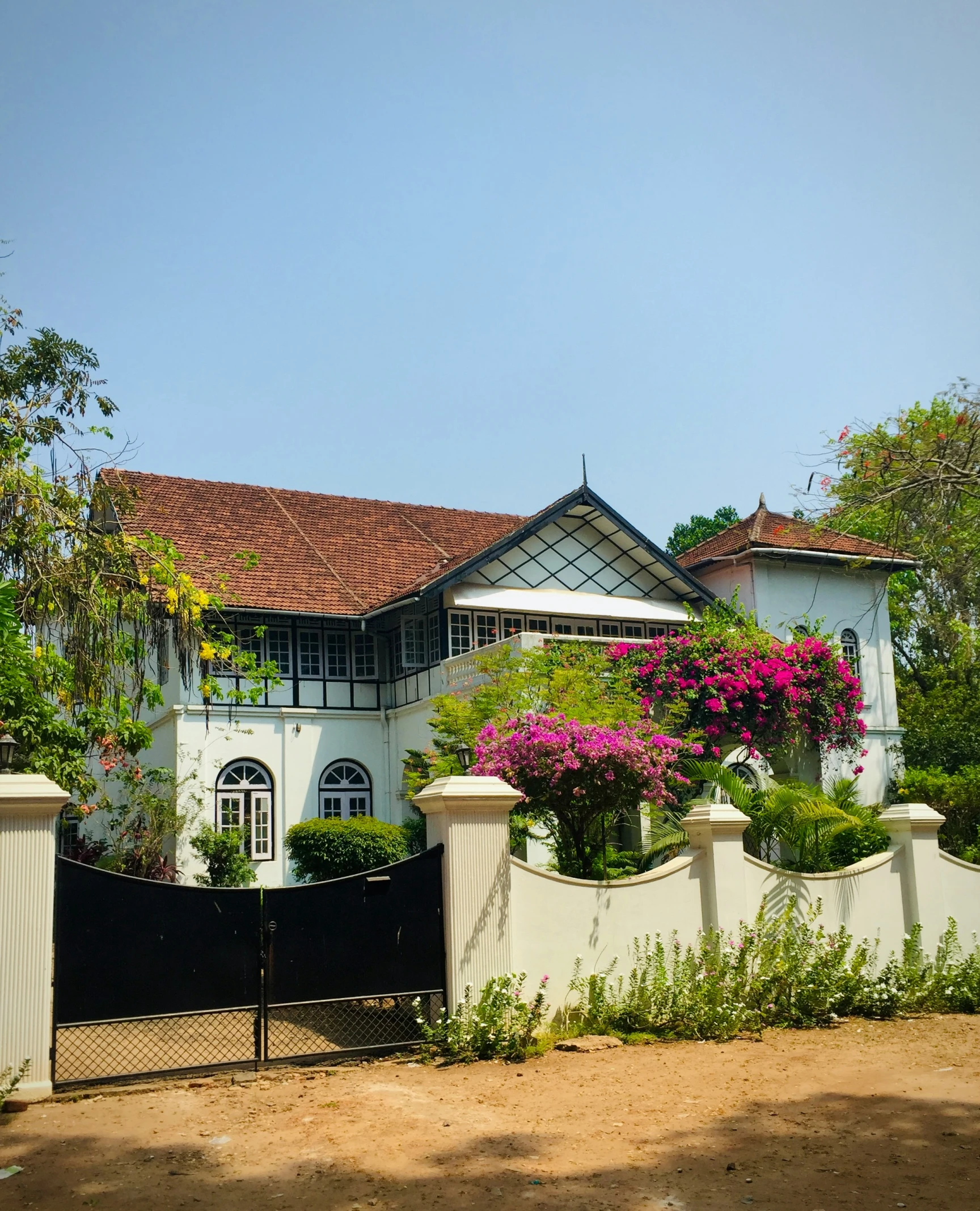 a house is shown with a white fence