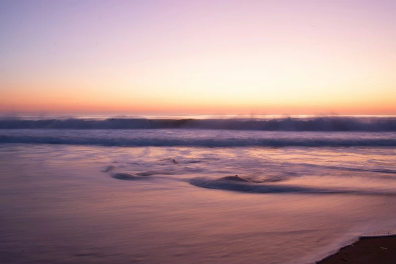 an ocean view with the sun shining over the waves