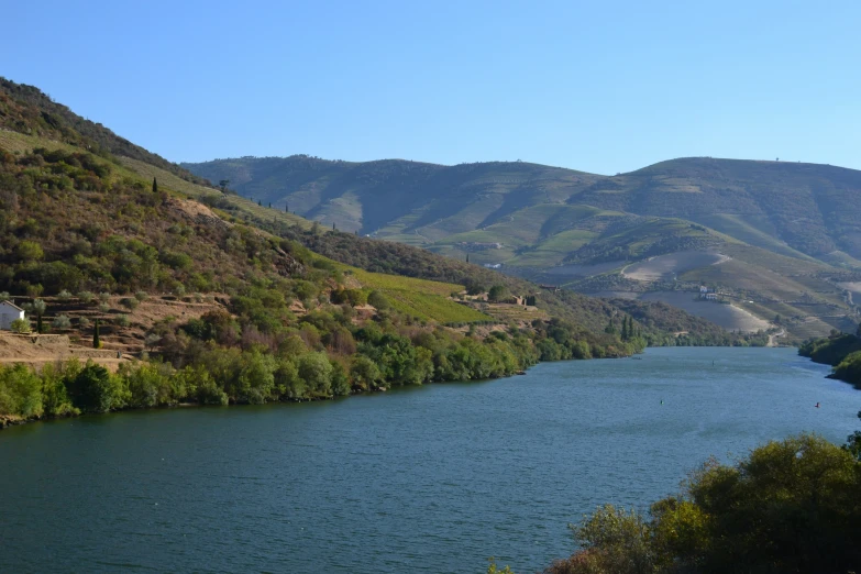 the mountains are behind the lake with a lot of water