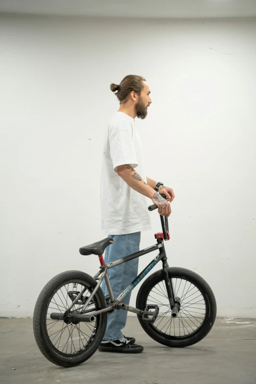 a man with a ponytail holding onto his bike