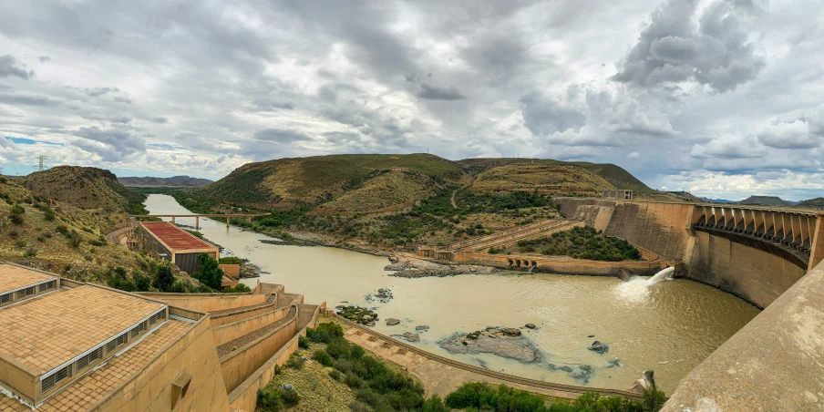 the view from a lookout looking at a river and a dam