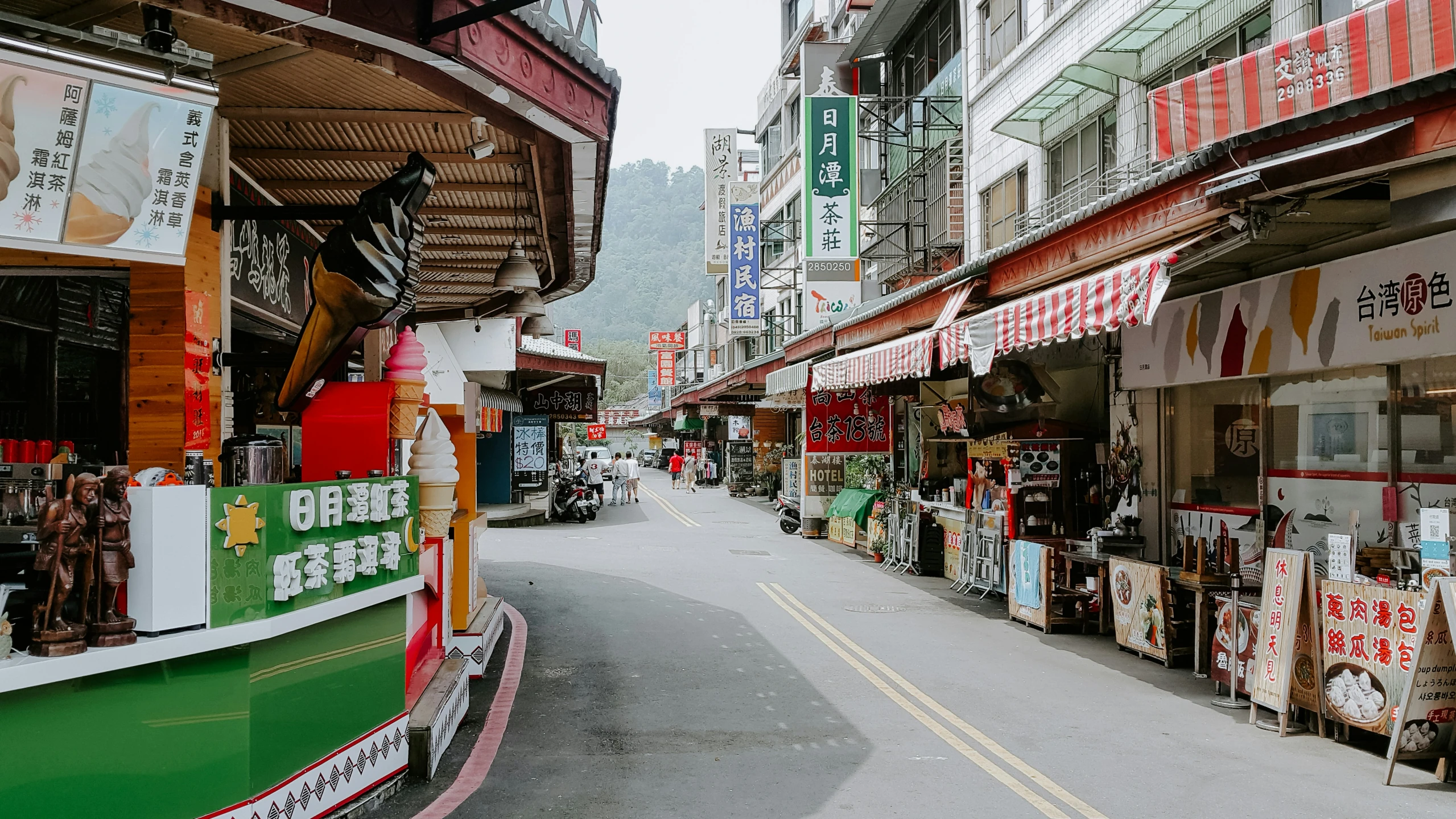 a shopping street lined with shops on both sides of the street