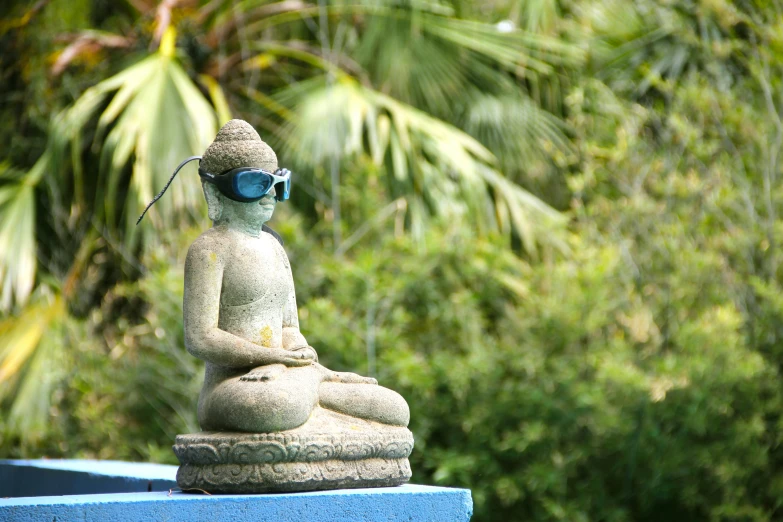 a stone buddha statue sits at the base of a wall