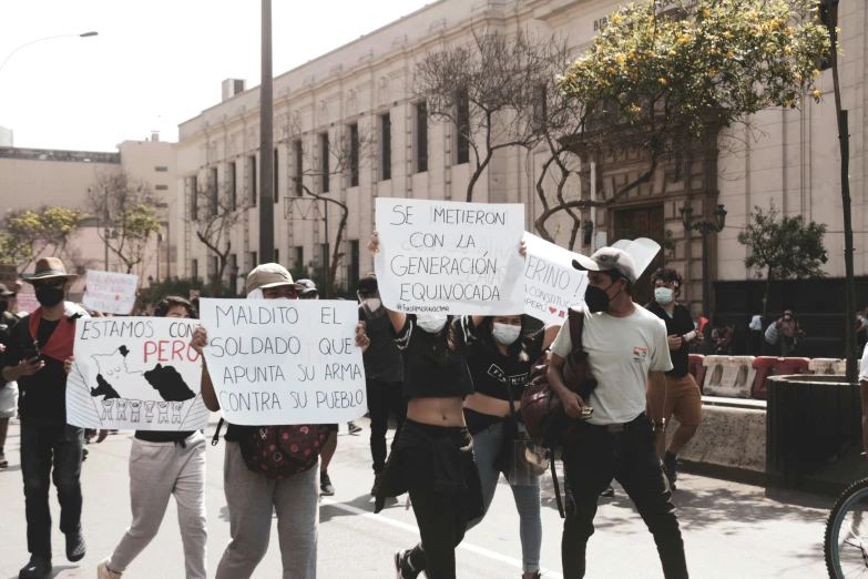 group of people holding up signs on a street