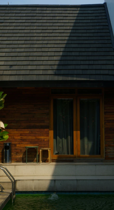 there is a boat tied up outside of a wooden house