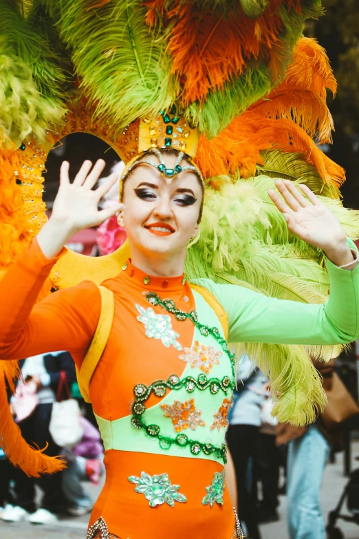 woman in green and orange costume with elaborate hair