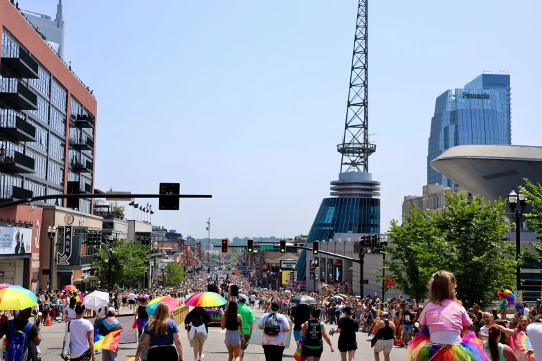 people walking down the sidewalk and buildings in the background