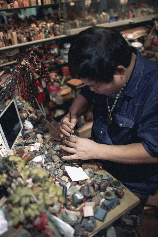 a boy looks at a display of miniature items in his shop