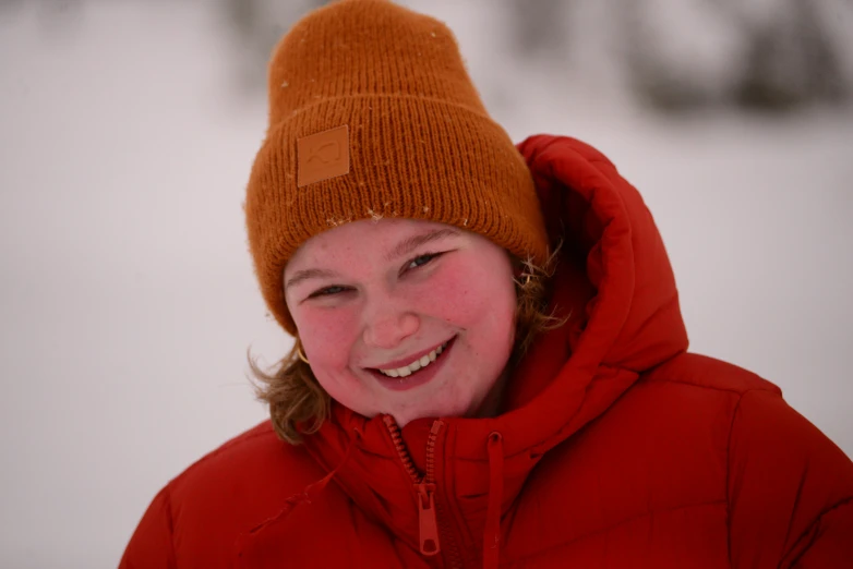 a  wearing a warm winter coat smiling