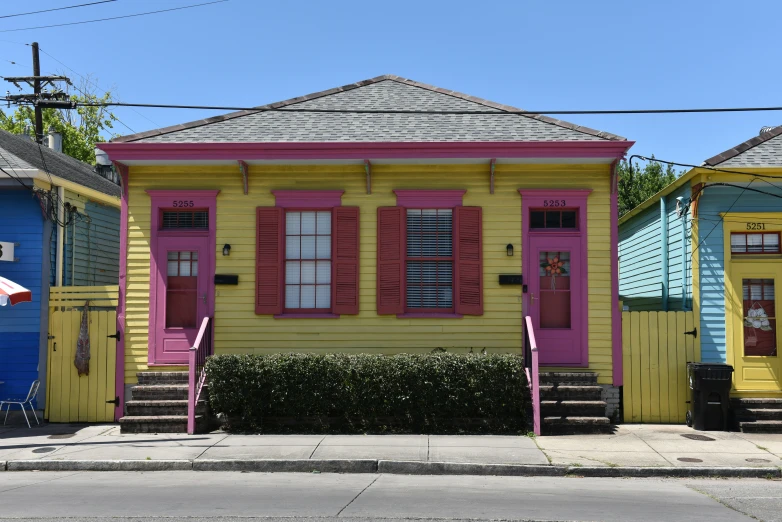 many houses painted brightly, one is pink, the other is blue