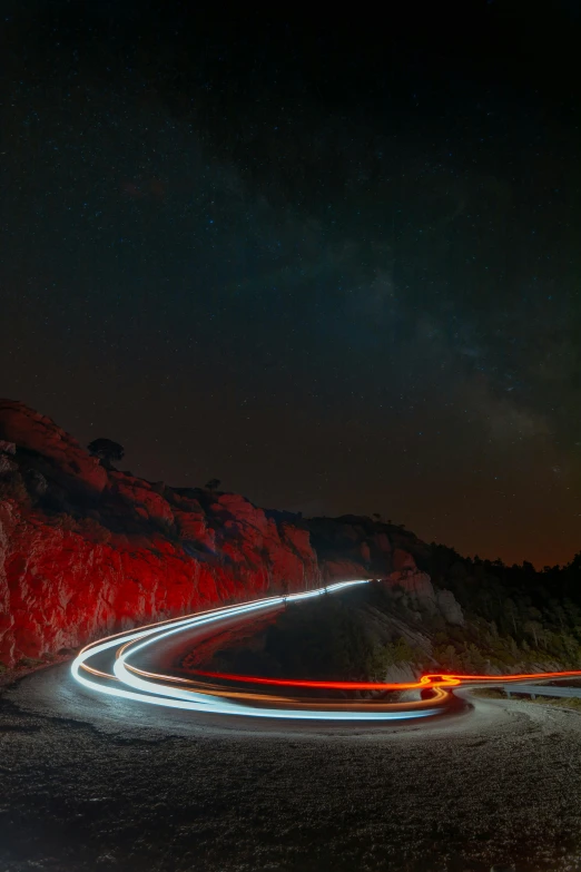 road winding up and over rocks under sky