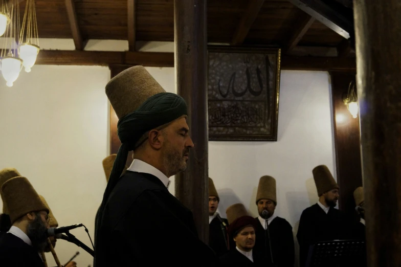 a group of men in hats at a ceremony
