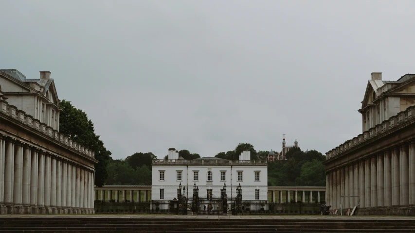 a large white building surrounded by some old columns