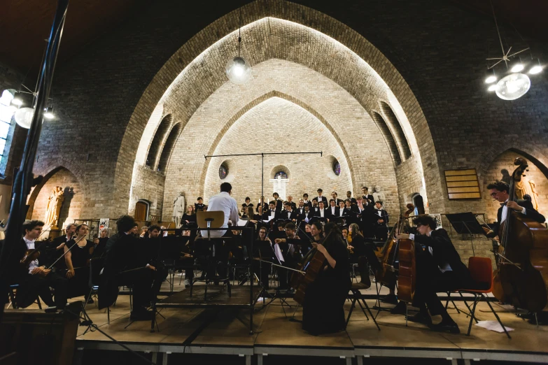 a conductor with orchestra equipment during a music concert