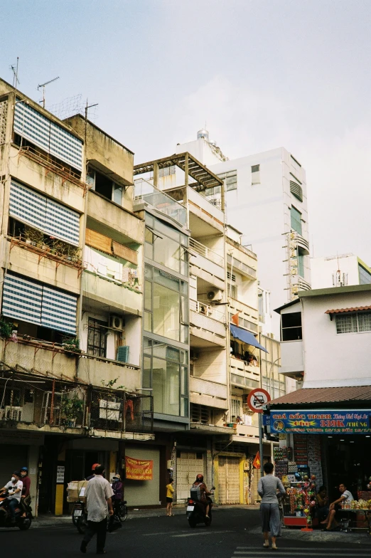 people are walking in the middle of an alley