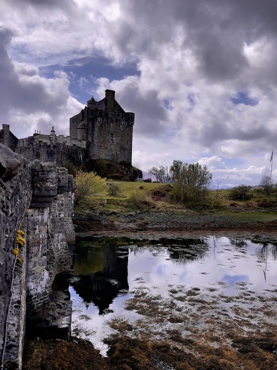 a reflection of the castle in a water hole