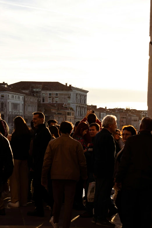 a group of people are looking at soing in the distance