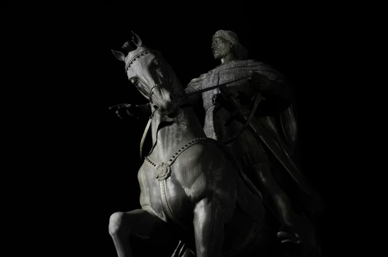 a black and white po of the statue of knight on horse