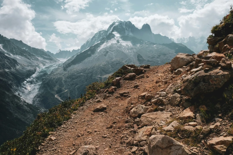 a mountain range with rocks and shrubbery below