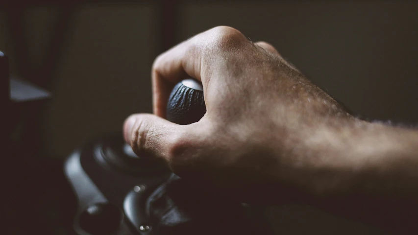 a close up of a person's hand holding an object with its thumb