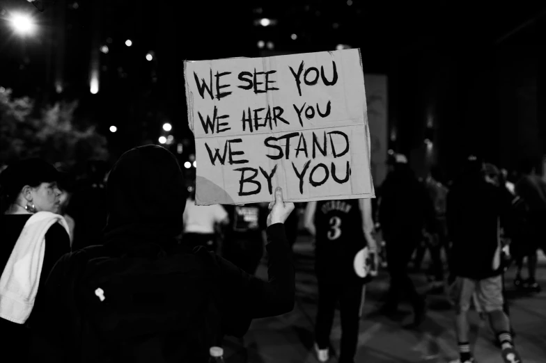 a protester has written on the sign while in front of the police