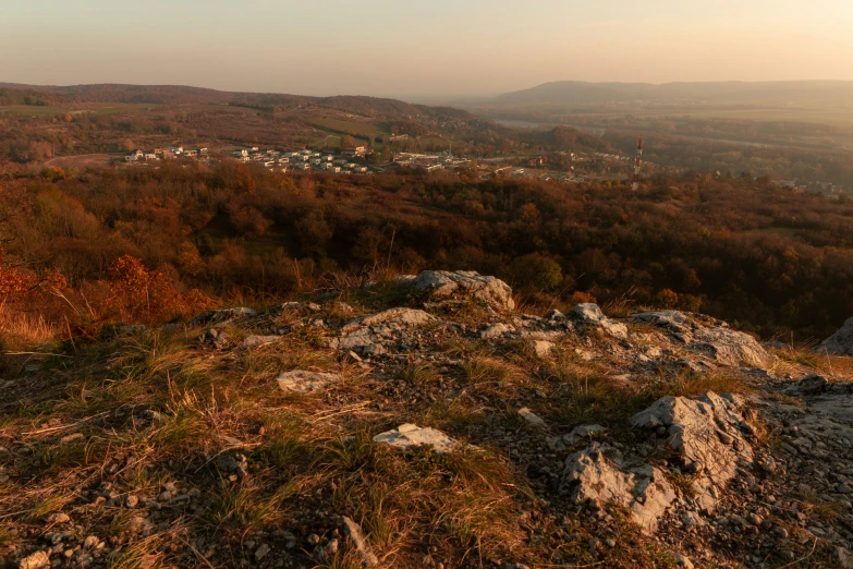 a view from the top of a hill at sunset