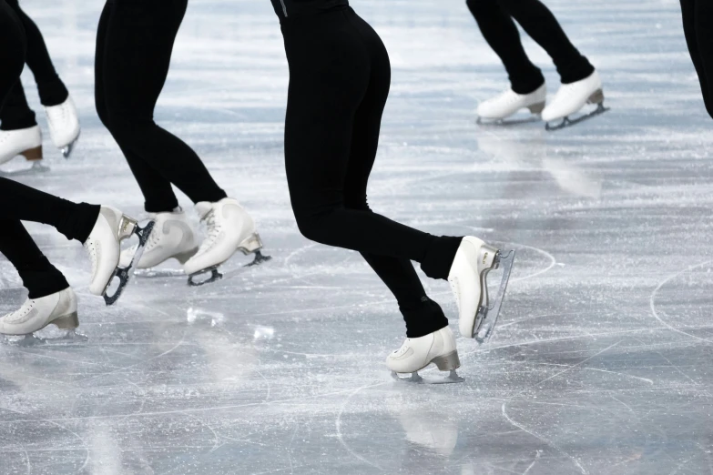 ice skaters in black and white skating on ice