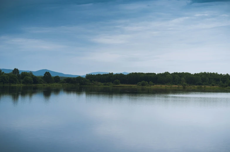 there is a lone boat floating on the lake